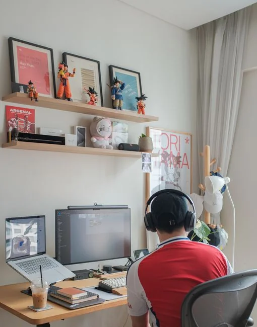 Close-up of a silver laptop and smartphone on a wooden desk, capturing modern work essentials.